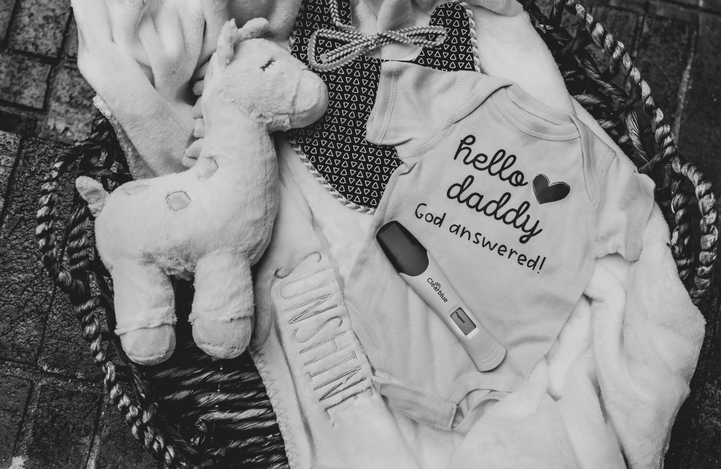 Baby clothes and newborn items arranged for a hospital bag